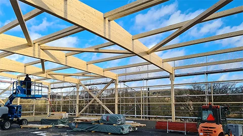 Weitere Seitenansicht der Montage des Holztragwerks der Lager- und Produktionshallen der Flachdach Solar GmbH + Co. KG