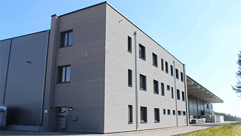 Seitliche Außenansicht und Eingangsbereich der neuen Abbundhalle HR Holzelement, Röttenbacher Holzbau